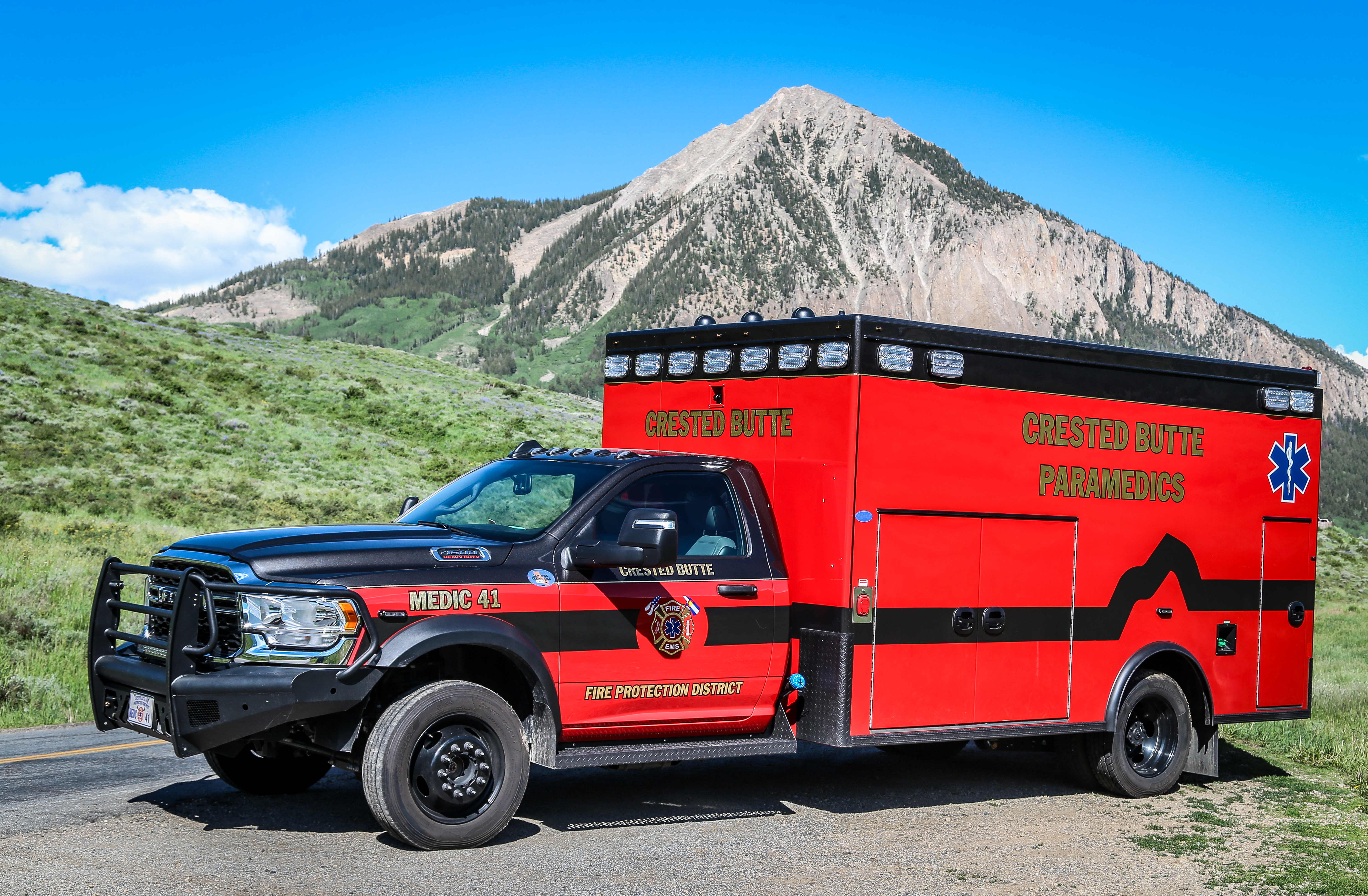 Photography of CBFPD Medic 41 ambulance on a street with a mountain in the background.